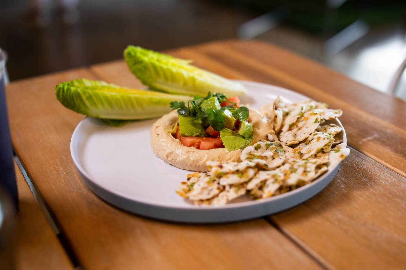 Hummus plate with avocado, tomato, herb crackers, and gem lettuce at McFlamingo Ponte Vedra Beach