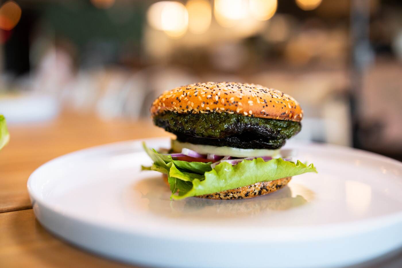 Close-up of an everything-bun smash burger at McFlamingo