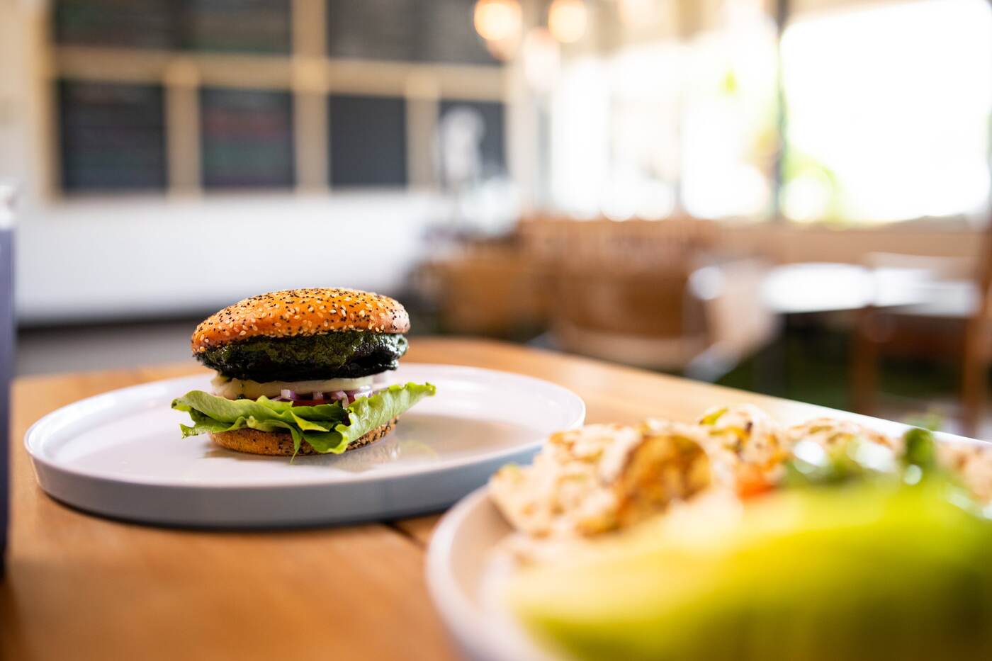 Everything smash burger on a white plate in the McFlamingo dining room