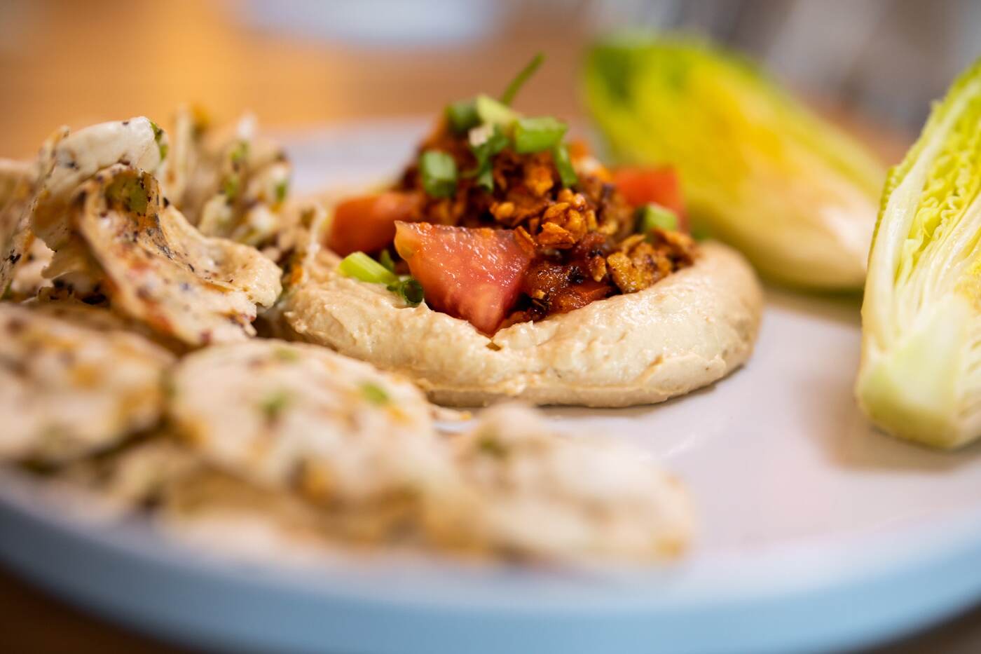 Spicy hummus plate with rice chips and gem lettuce at McFlamingo