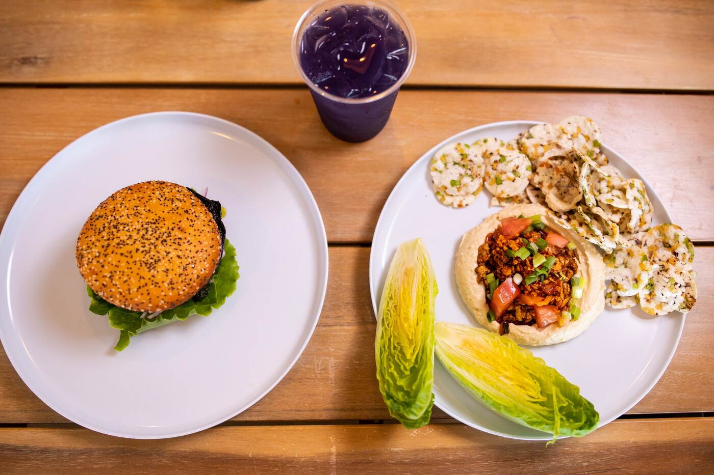 Overhead of smash burger, hummus plate, and purple cooler at McFlamingo