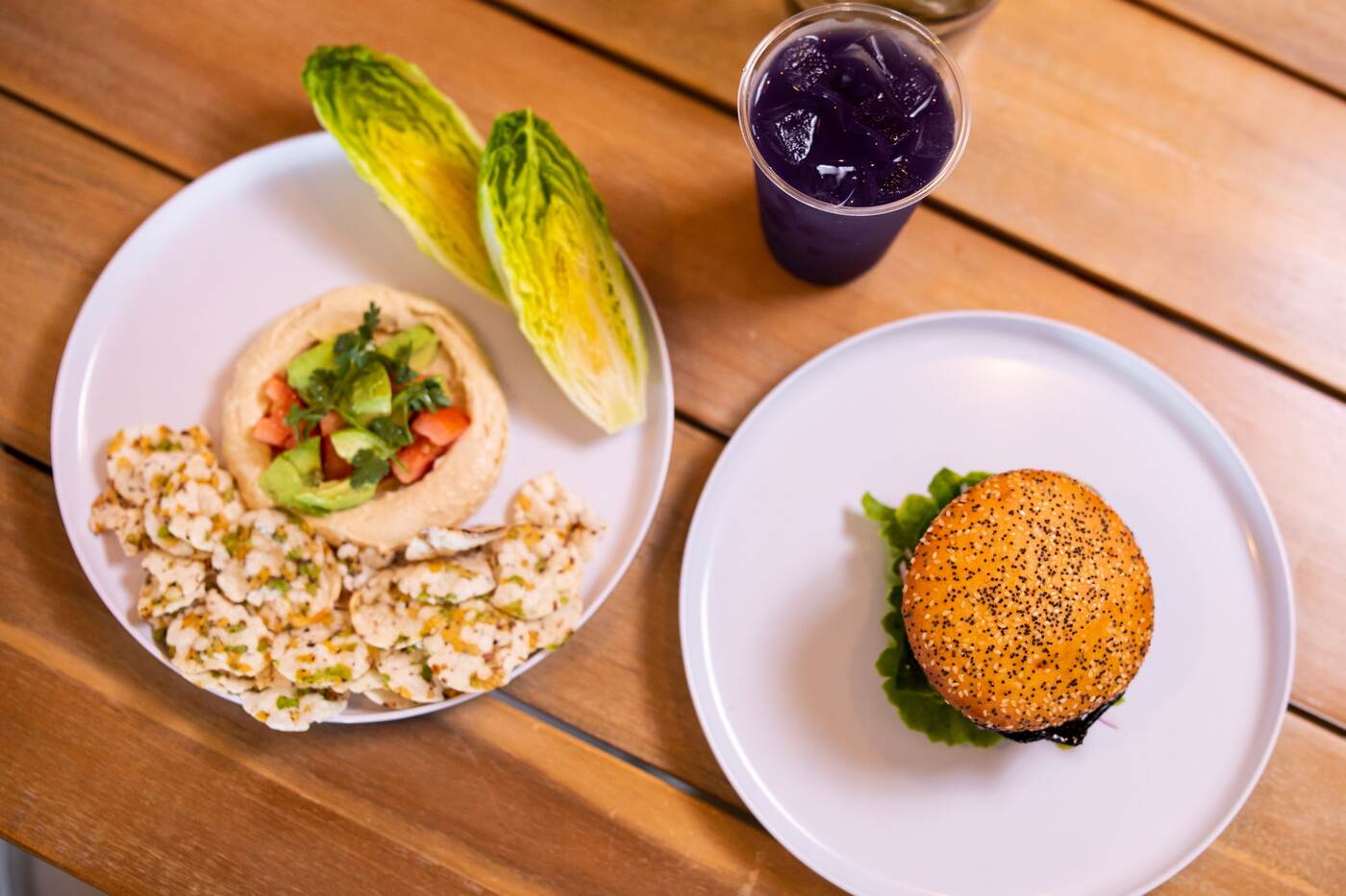 Overhead of hummus, smash burger, and purple drink at McFlamingo